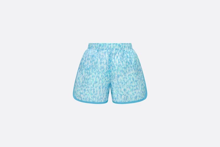 Children's swimmers.  Dip dyeing of printed scientific and technological fabrics with Dior Oblique in maze and ivory colors.  Numbering: 3WBM21SWMB_Y160